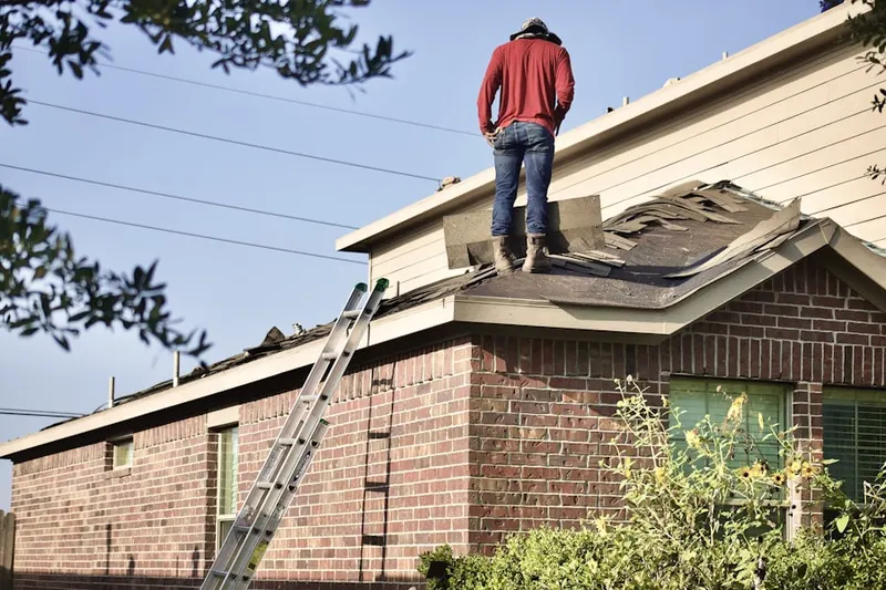 Professional roofer working on a residential roof in Dougherty